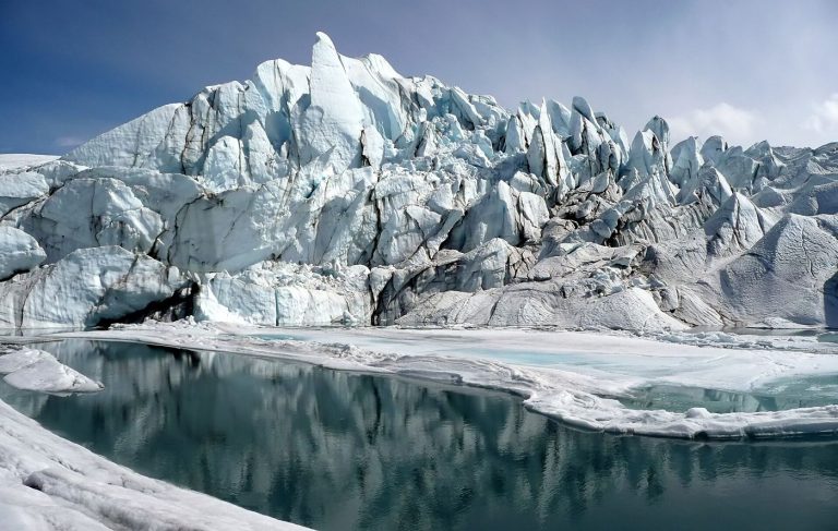 A glacial lake beneath ice-covered peaks